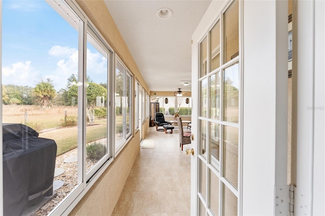 sunroom featuring ceiling fan