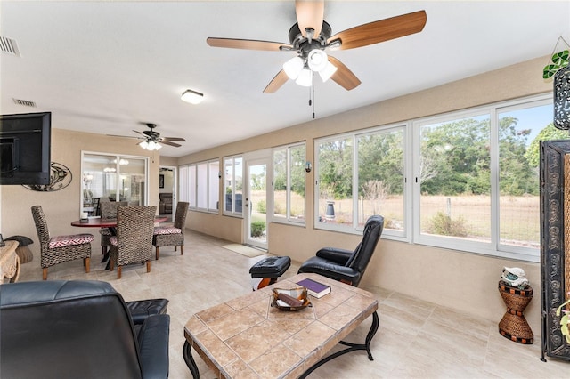 sunroom / solarium with ceiling fan