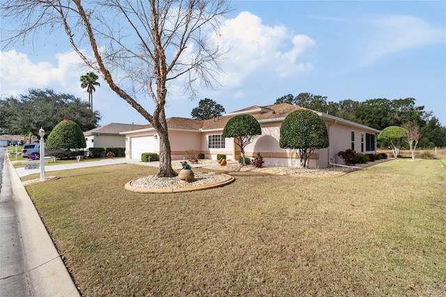 view of front of property with a garage and a front lawn