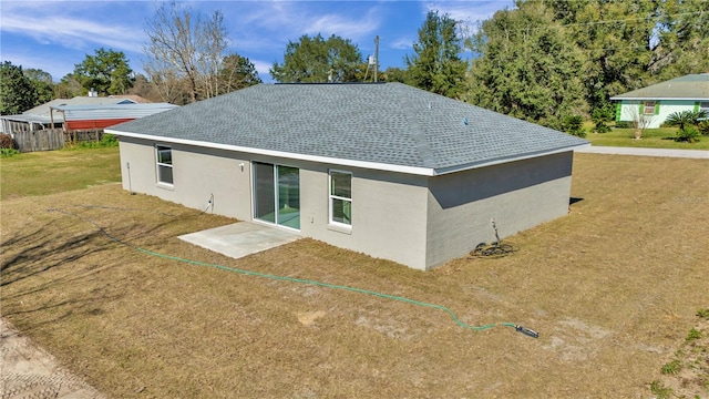 back of house featuring a yard