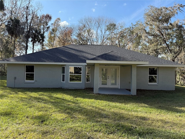 rear view of property with a lawn and a patio