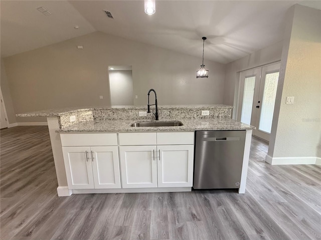 kitchen with white cabinetry, sink, hanging light fixtures, stainless steel dishwasher, and lofted ceiling