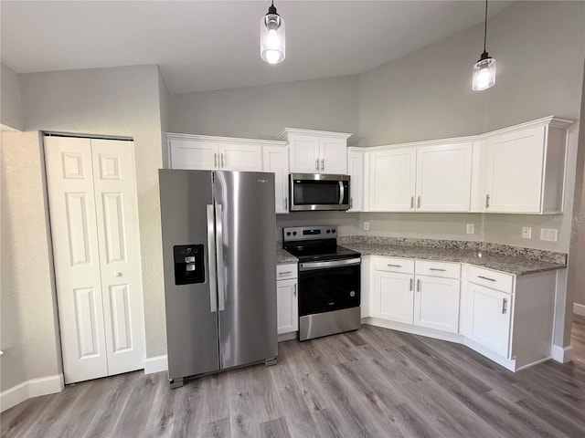 kitchen featuring white cabinetry, pendant lighting, and appliances with stainless steel finishes