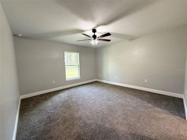 carpeted empty room featuring ceiling fan and a textured ceiling