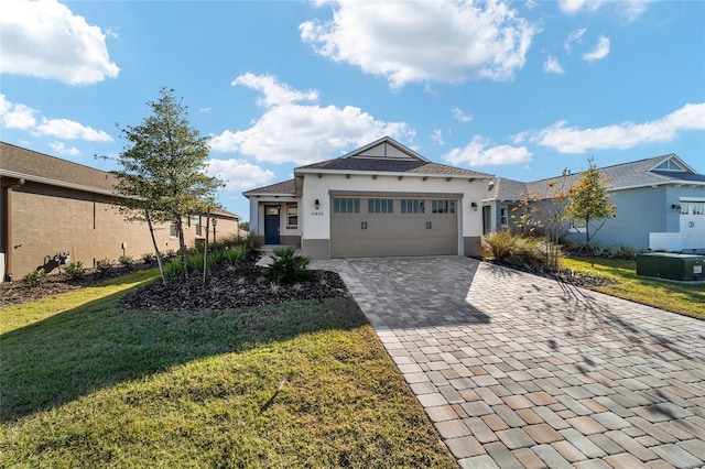 view of front of property featuring a front yard and a garage