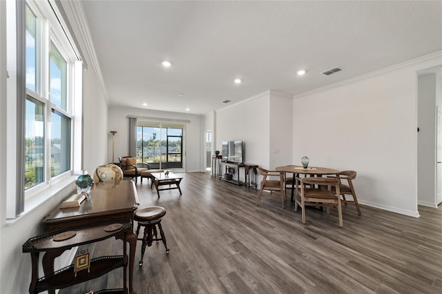 dining space with crown molding and dark wood-type flooring