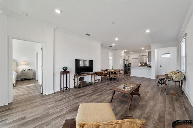 living room with light hardwood / wood-style floors and ornamental molding