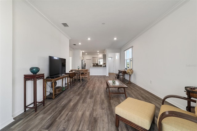 living room with dark wood-type flooring and ornamental molding