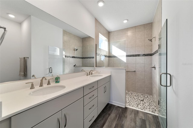 bathroom with vanity, wood-type flooring, and walk in shower