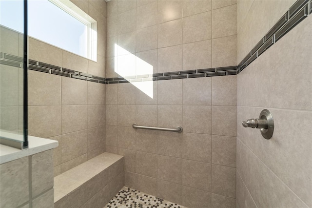 bathroom with tiled shower