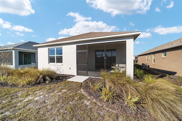 rear view of property with a sunroom