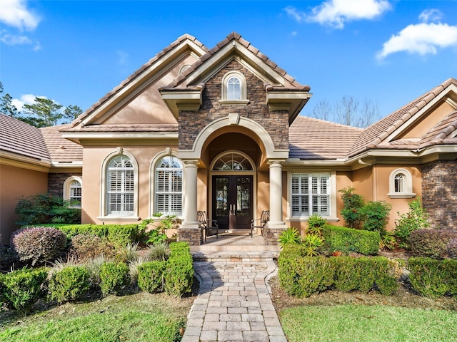 view of exterior entry featuring french doors