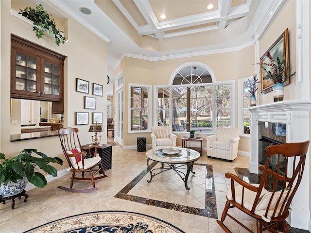 living area with ornamental molding, coffered ceiling, a premium fireplace, beamed ceiling, and a high ceiling