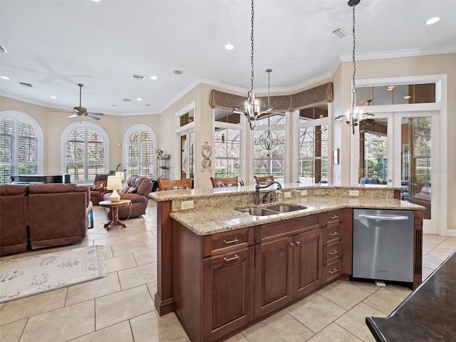 kitchen with light stone counters, stainless steel dishwasher, ceiling fan with notable chandelier, sink, and pendant lighting