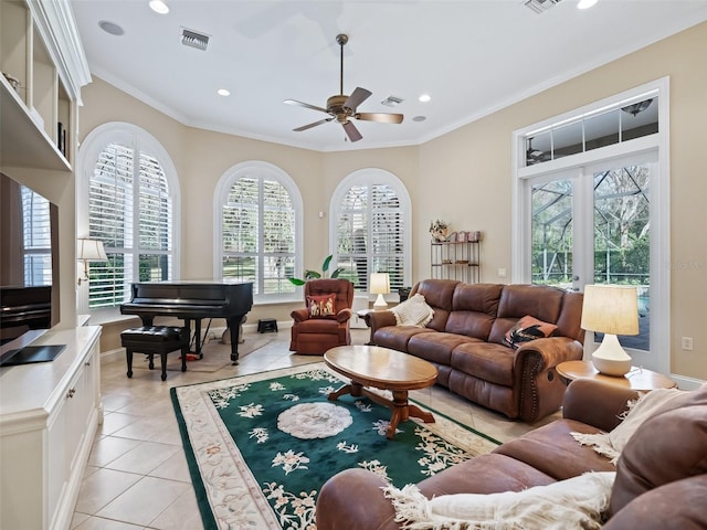 tiled living room with french doors, ceiling fan, and ornamental molding