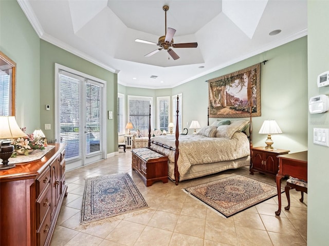 bedroom with ceiling fan, access to exterior, ornamental molding, and a tray ceiling