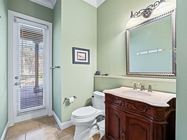 bathroom with tile patterned flooring, vanity, toilet, and crown molding