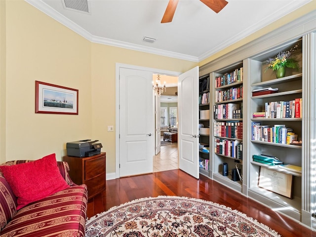 sitting room featuring ceiling fan with notable chandelier, dark hardwood / wood-style flooring, and crown molding