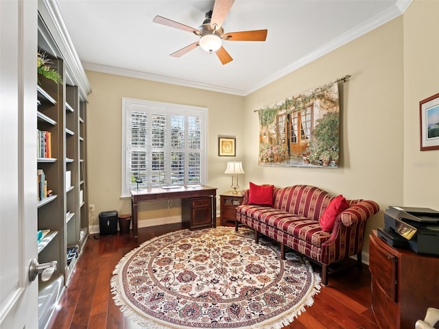 sitting room with dark hardwood / wood-style floors, ceiling fan, and crown molding