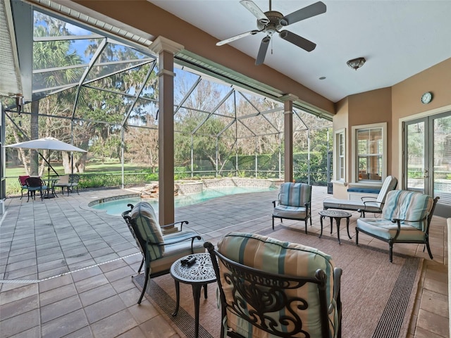 view of patio with a lanai, outdoor lounge area, and ceiling fan