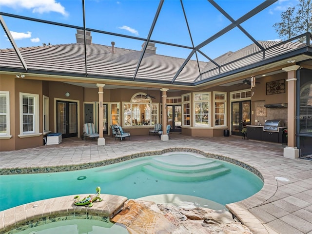 view of swimming pool with grilling area, ceiling fan, and a patio area