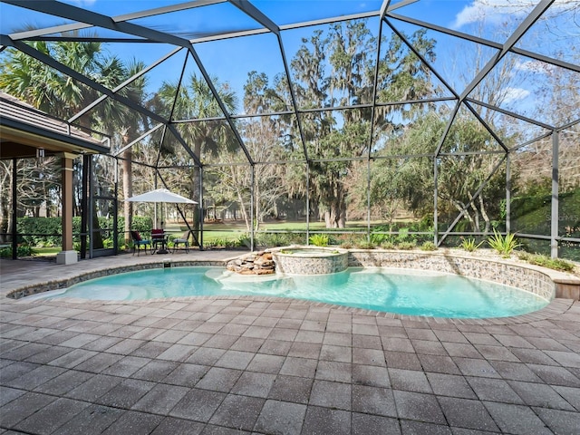 view of pool featuring glass enclosure, a patio area, and an in ground hot tub