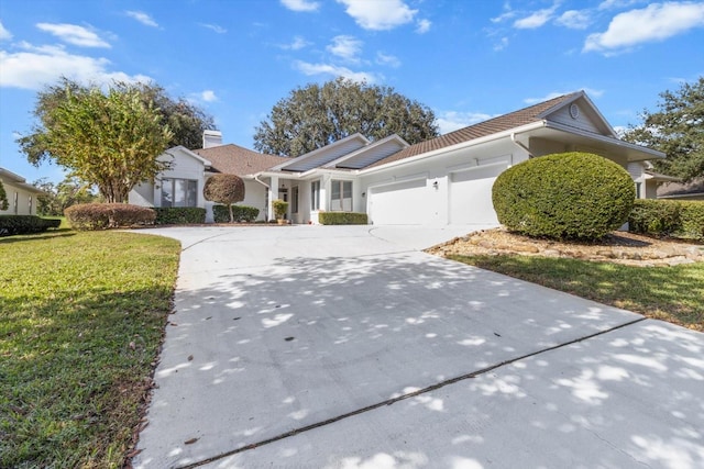 view of front of property with a garage and a front yard