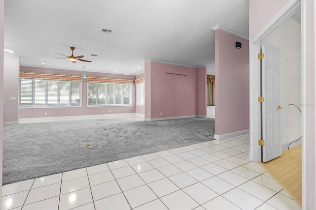 interior space with ceiling fan, light colored carpet, and crown molding