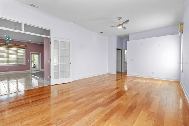 unfurnished room featuring ceiling fan, crown molding, and light hardwood / wood-style floors