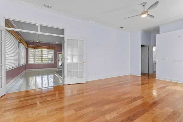 empty room featuring light hardwood / wood-style flooring, ceiling fan, and ornamental molding