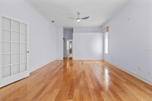 spare room featuring ceiling fan, light hardwood / wood-style flooring, and ornamental molding