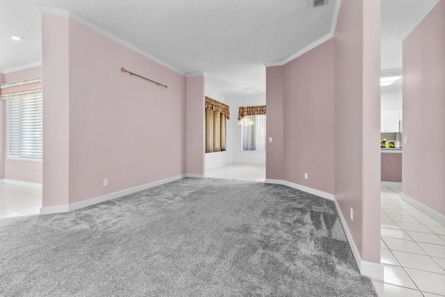 spare room featuring light colored carpet and ornamental molding