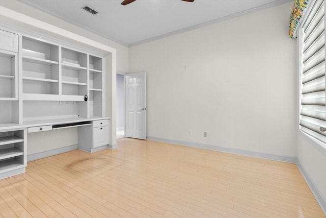 unfurnished office featuring ceiling fan, light wood-type flooring, and crown molding