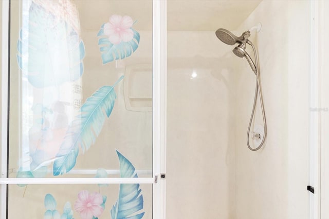 bathroom featuring a shower with door