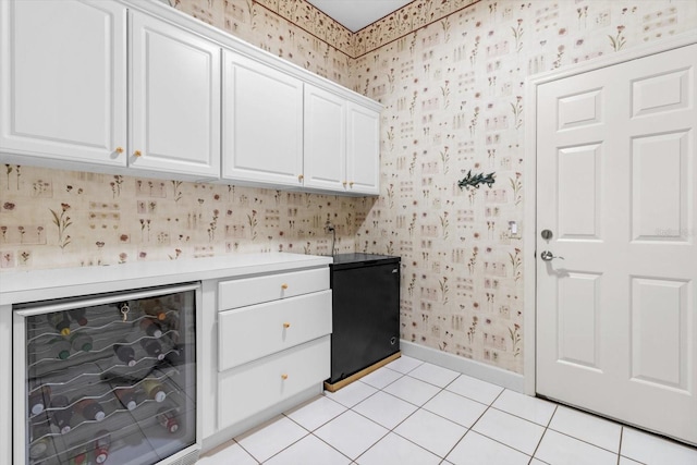 laundry area featuring light tile patterned floors and beverage cooler