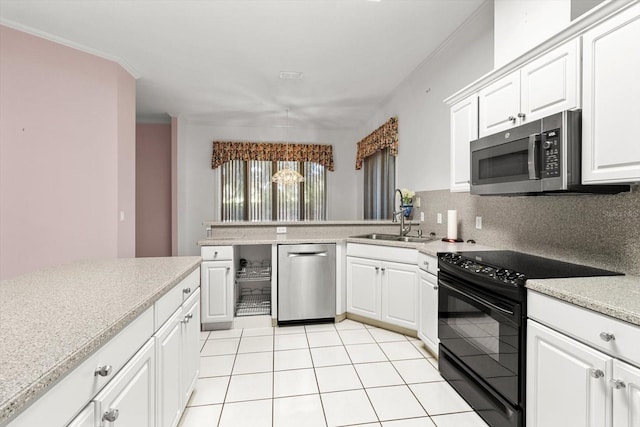 kitchen with backsplash, white cabinetry, sink, and stainless steel appliances