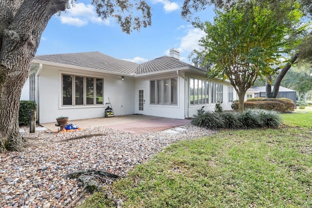 back of property with a patio