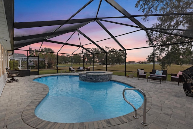 pool at dusk featuring a lawn, glass enclosure, an in ground hot tub, and a patio