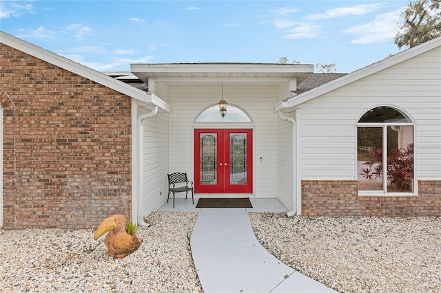 view of exterior entry featuring french doors