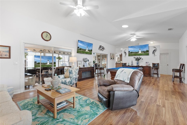 living room featuring light wood-type flooring, ceiling fan, lofted ceiling, and billiards