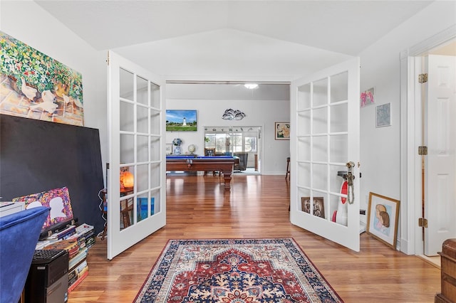 interior space with built in shelves, french doors, billiards, wood-type flooring, and lofted ceiling