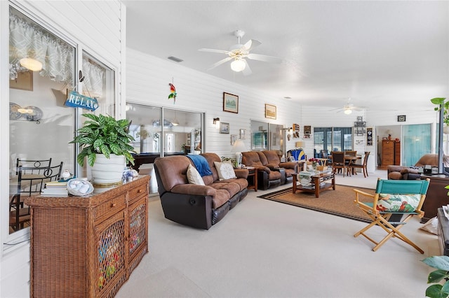 living room with light colored carpet and ceiling fan