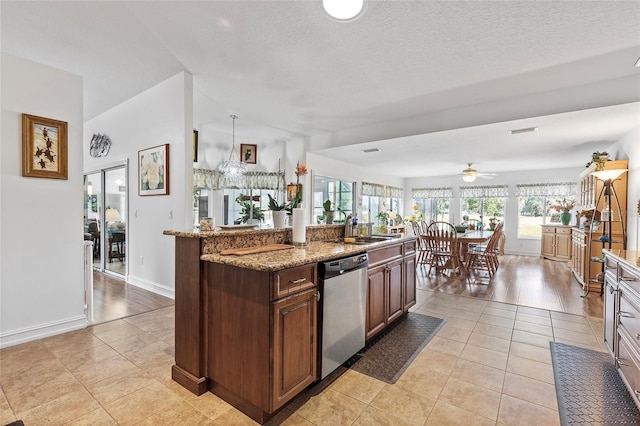 kitchen featuring ceiling fan, dishwasher, sink, a kitchen island with sink, and light tile patterned floors