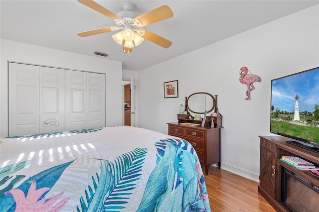 bedroom featuring ceiling fan, a closet, and light hardwood / wood-style floors