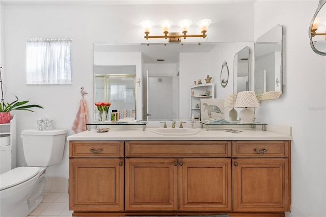 bathroom featuring tile patterned flooring, vanity, toilet, and walk in shower