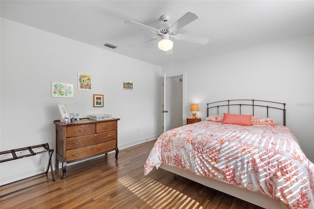 bedroom featuring ceiling fan and dark wood-type flooring