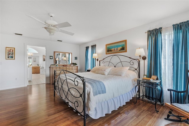 bedroom featuring ensuite bath, ceiling fan, and dark wood-type flooring