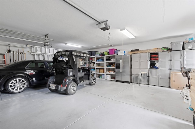 garage with stainless steel fridge with ice dispenser and a garage door opener