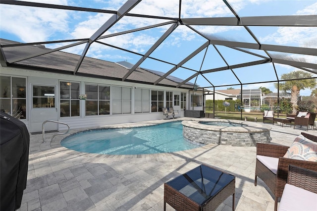 view of pool with an in ground hot tub, glass enclosure, a patio area, and a grill