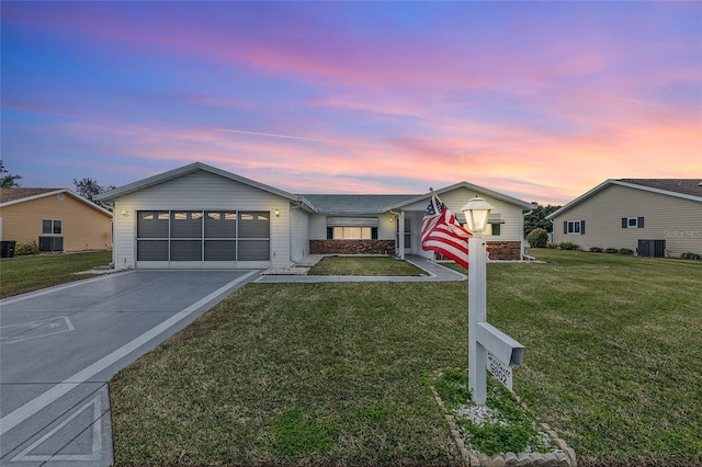 ranch-style house with a lawn and cooling unit